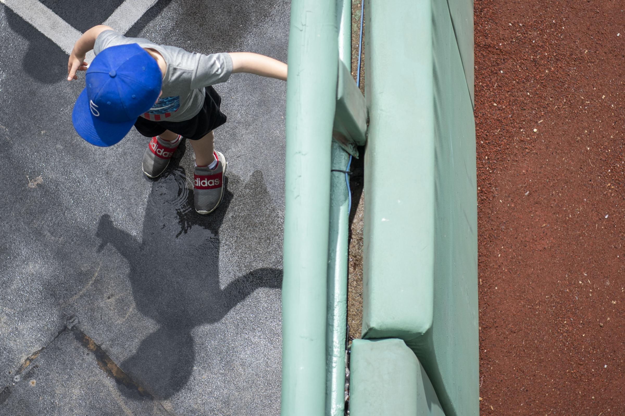 The 2023 Boston Red Sox  - June 18, 2023, Boston, MA: A young fan plays in a puddle...