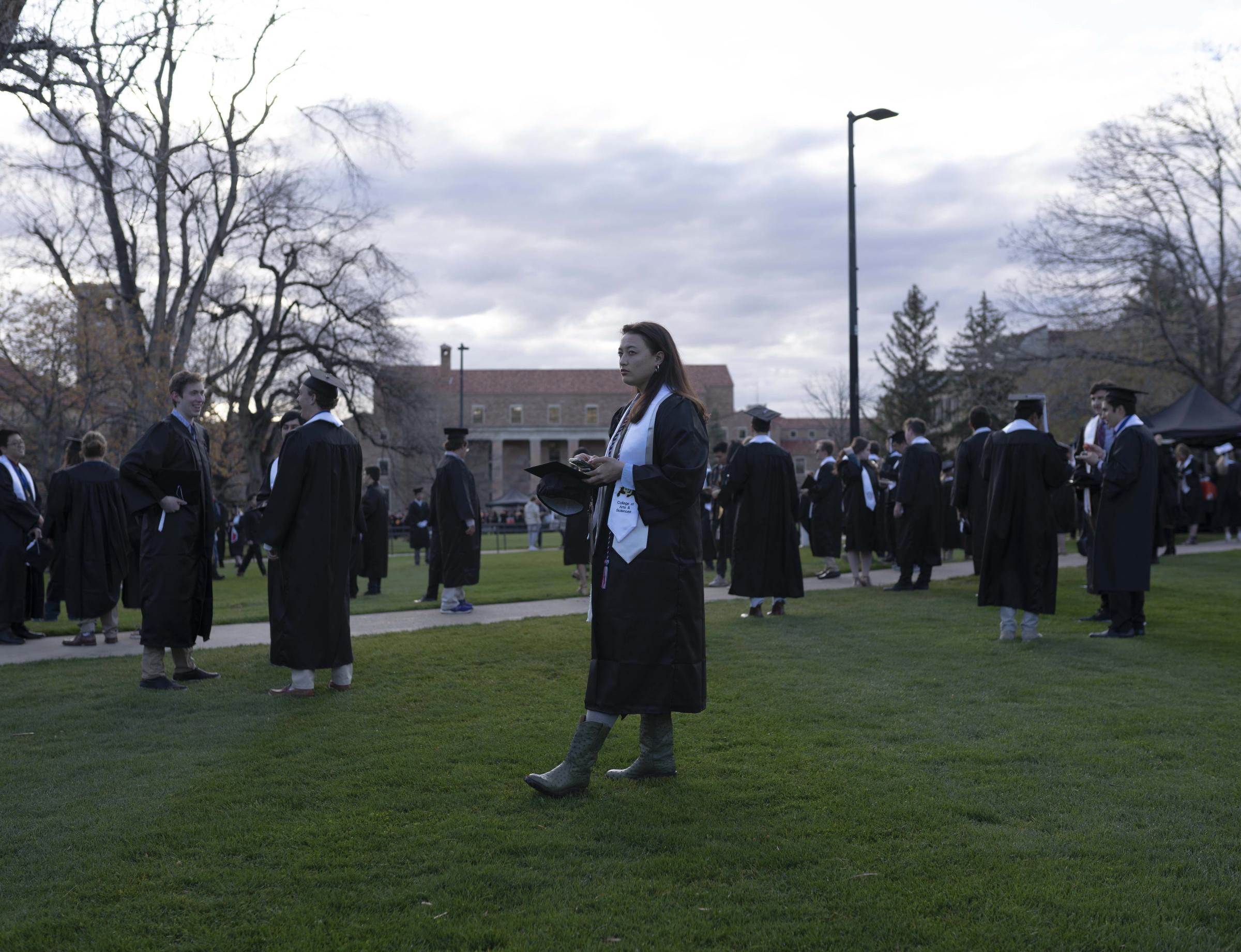 CU Boulder Commencement  - CU Arts and Sciences graduate Jace Gibson waits on Norlin...