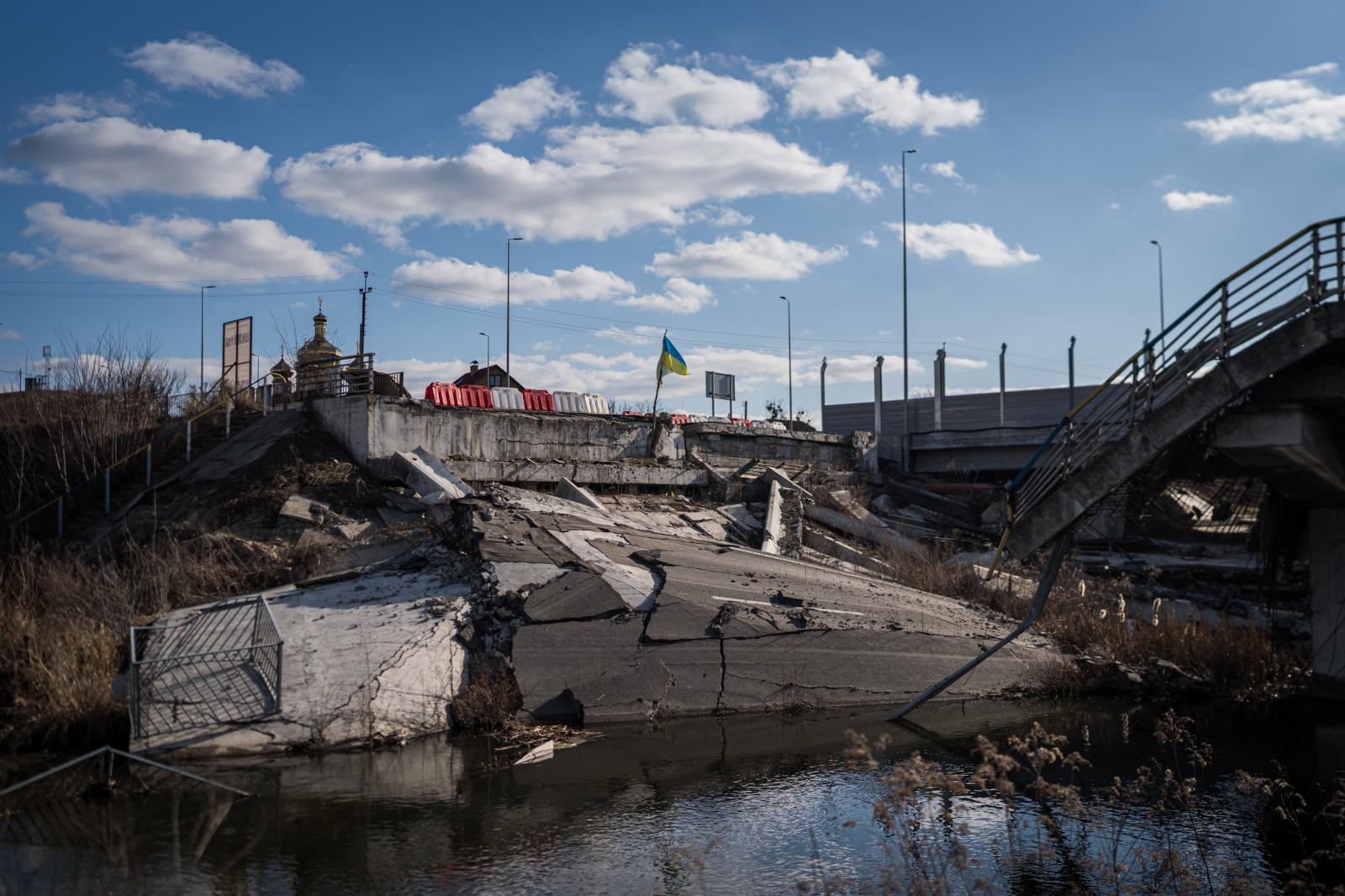 Ukraine: Second year of war - IRPIN, UKRAINE - MARCH 9: Destroyed city entrance bridge where a memorial has been placed to...