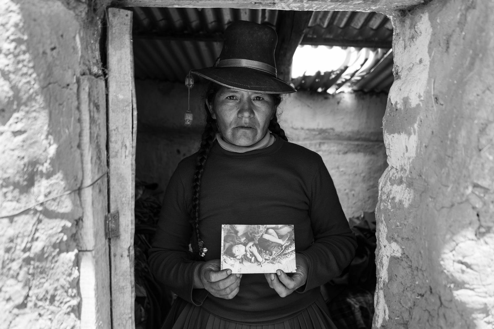 Eulogia Guzmán holds a picture ...e in the heights of Cusco. Peru
