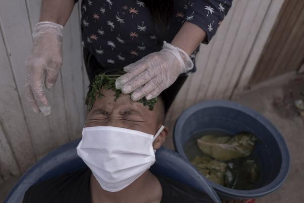 Image from DOCU - Juan Alcides Clemente (12), is being treated with plants...