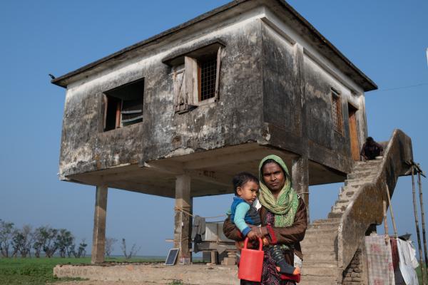 For NPR: Facing floods: What the world can learn from Bangladesh's climate solutions - Kelna Begum, 30, a residence of Golabari village holds her kid and pose for a photo at Tahirpur...