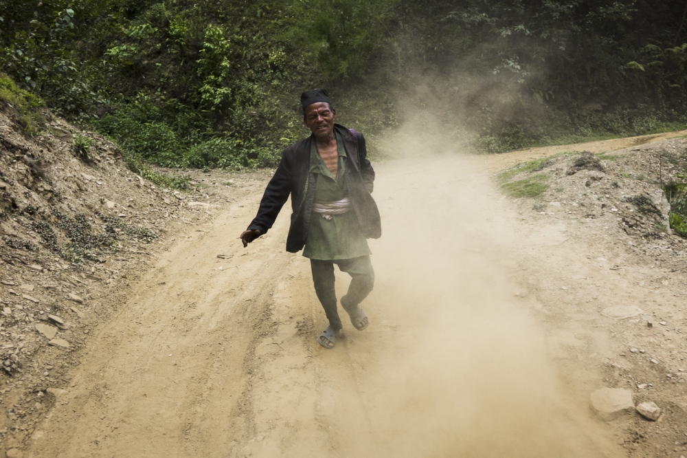  A Nepali man tries to run afte...lage. Sindhulpalchok district. 