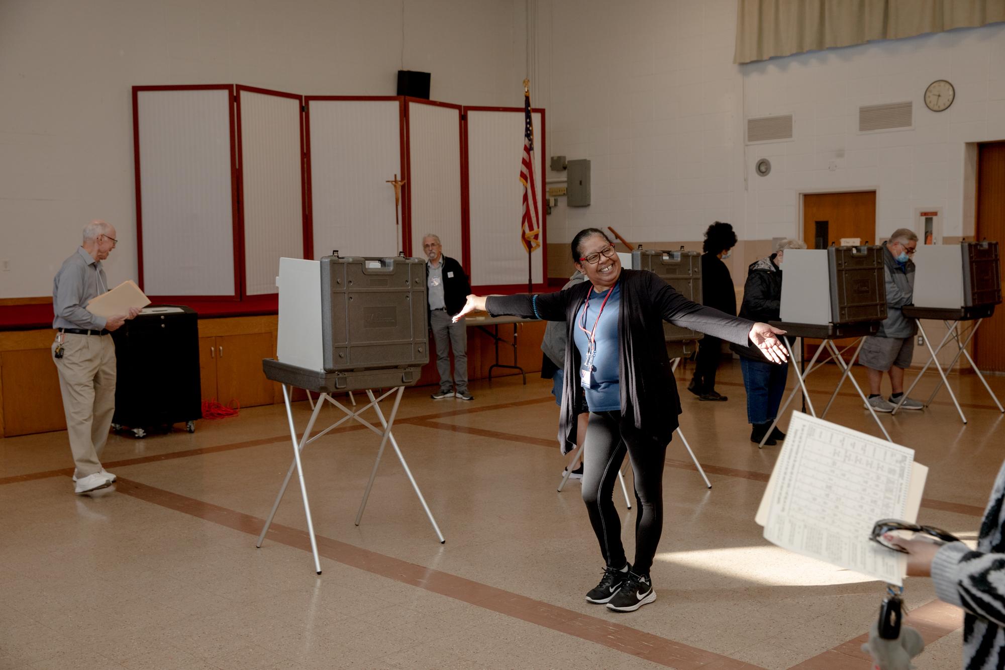 Recent Assignment - Ivonne Alvarez, a moderator at the polling site, guides a...
