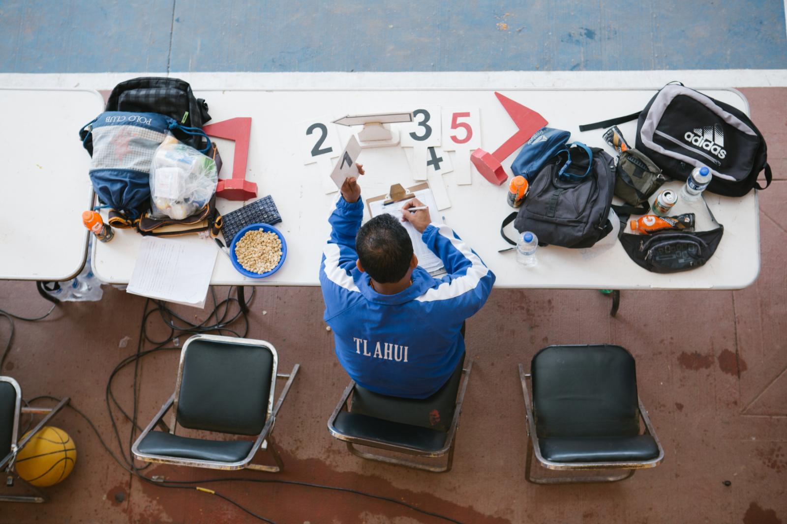 Image from Basketball in the Sierra Norte of Oaxaca - A referee keeps track of fouls during a basketball game...