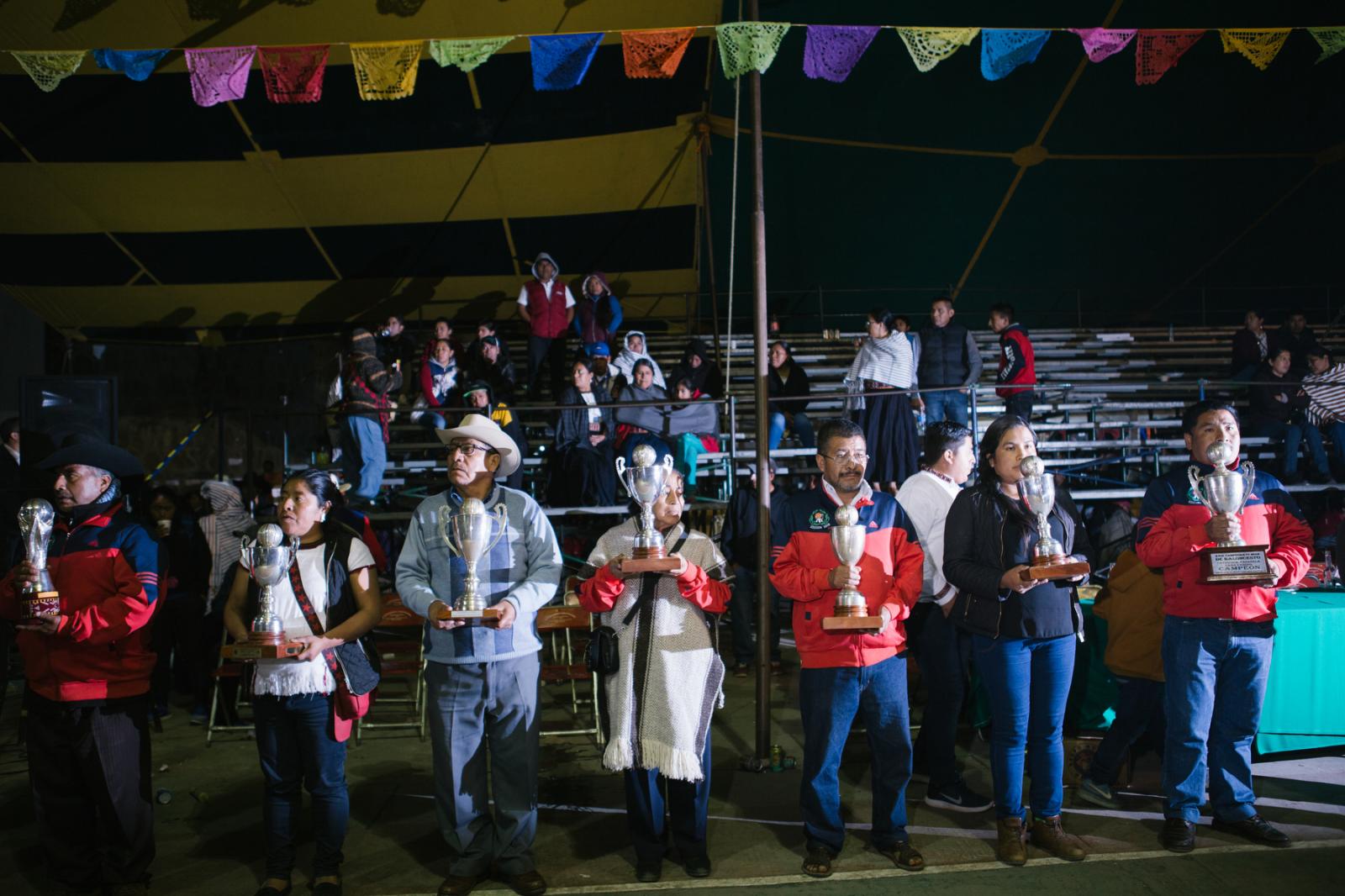 Image from Basketball in the Sierra Norte of Oaxaca - Sports organizers hold the silver cups for those who have...