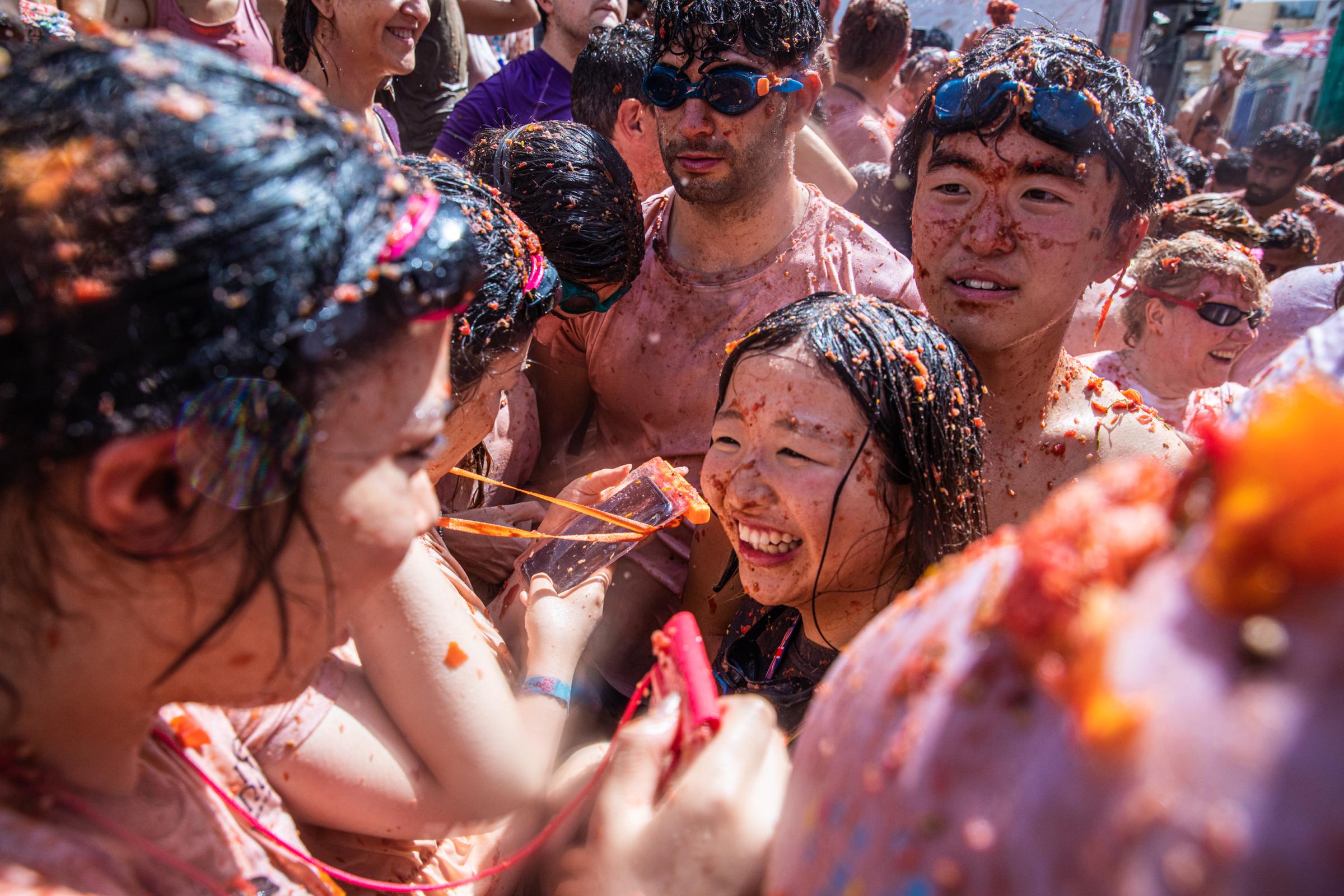 Spain's Tomato Throwing Festival Returns After Covid Hiatus For The 75th Edition - BUNOL, SPAIN - AUGUST 31: Asian revelers enjoy La...