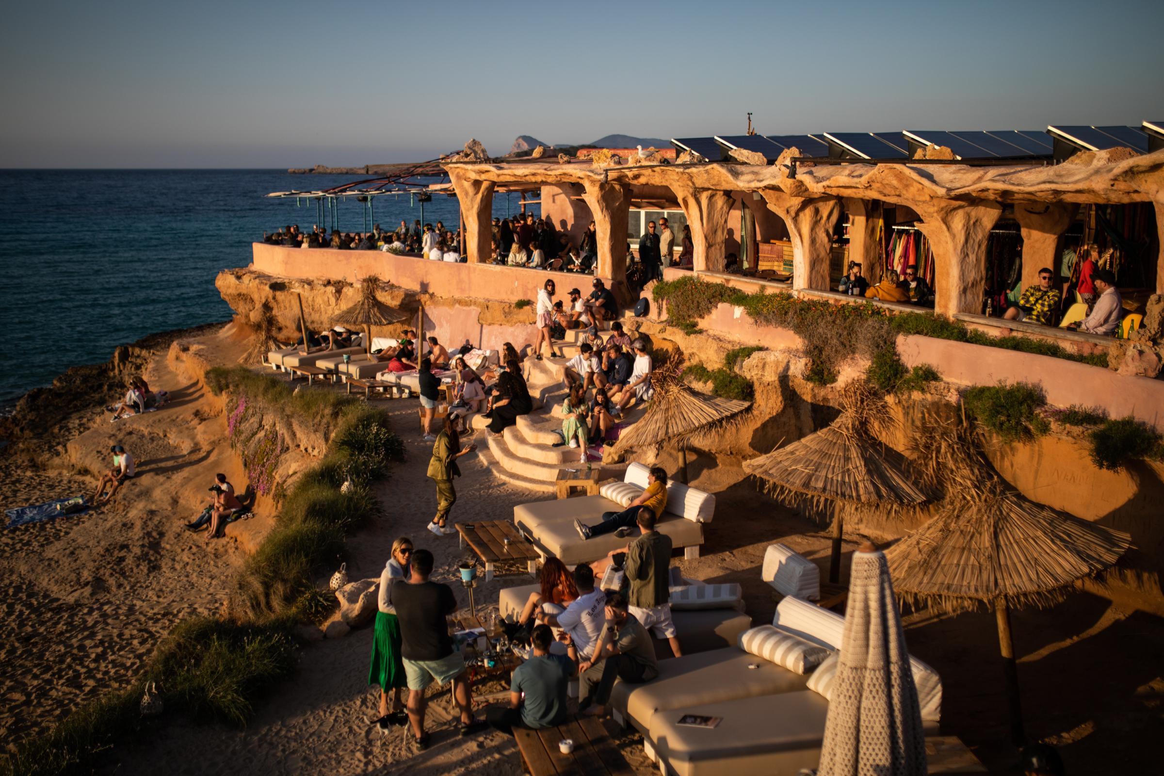 Grand Opening At Pacha Ibiza Heralds A Pre-Pandemic Party Season - Tourists enjoy the sunset at the Sunset Ashram beach bar...