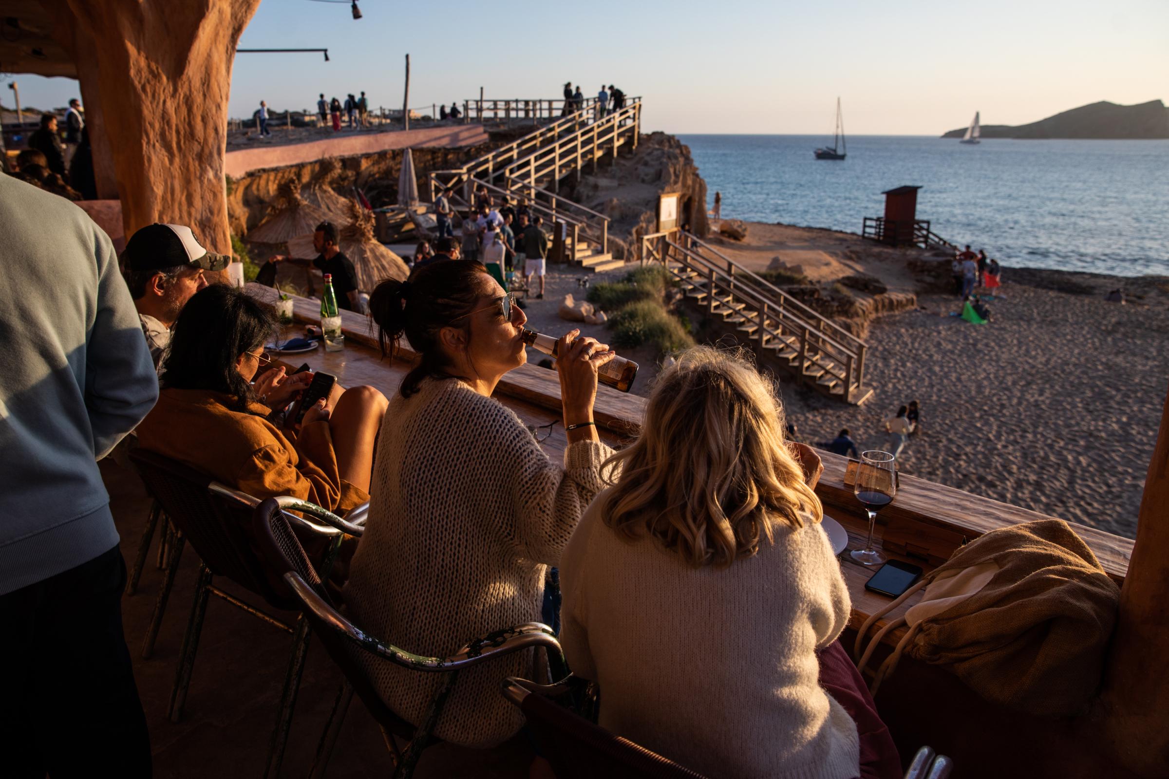 Grand Opening At Pacha Ibiza Heralds A Pre-Pandemic Party Season - Tourists enjoy the sunset at the Sunset Ashram beach bar...
