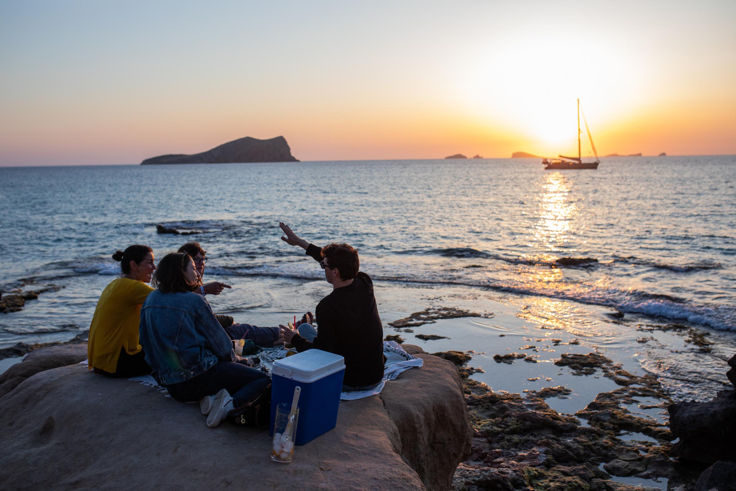 Grand Opening At Pacha Ibiza Heralds A Pre-Pandemic Party Season - Tourists enjoy the sunset at Escondida beach on April 29,...