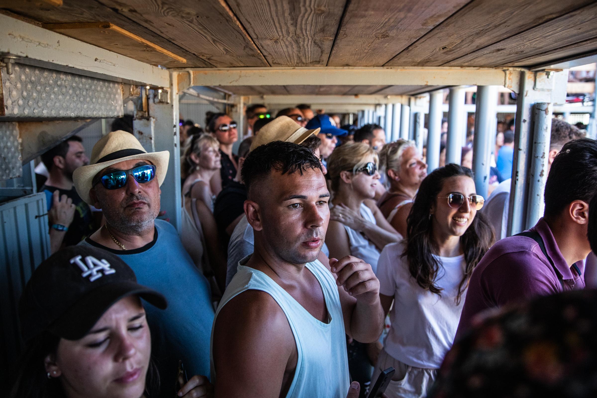 At 'Bous A La Mar', Revelers Take Plunge To Dodge Bulls And Beat The Heat - DENIA, SPAIN - JULY 17: Turistas observan asombrados la...