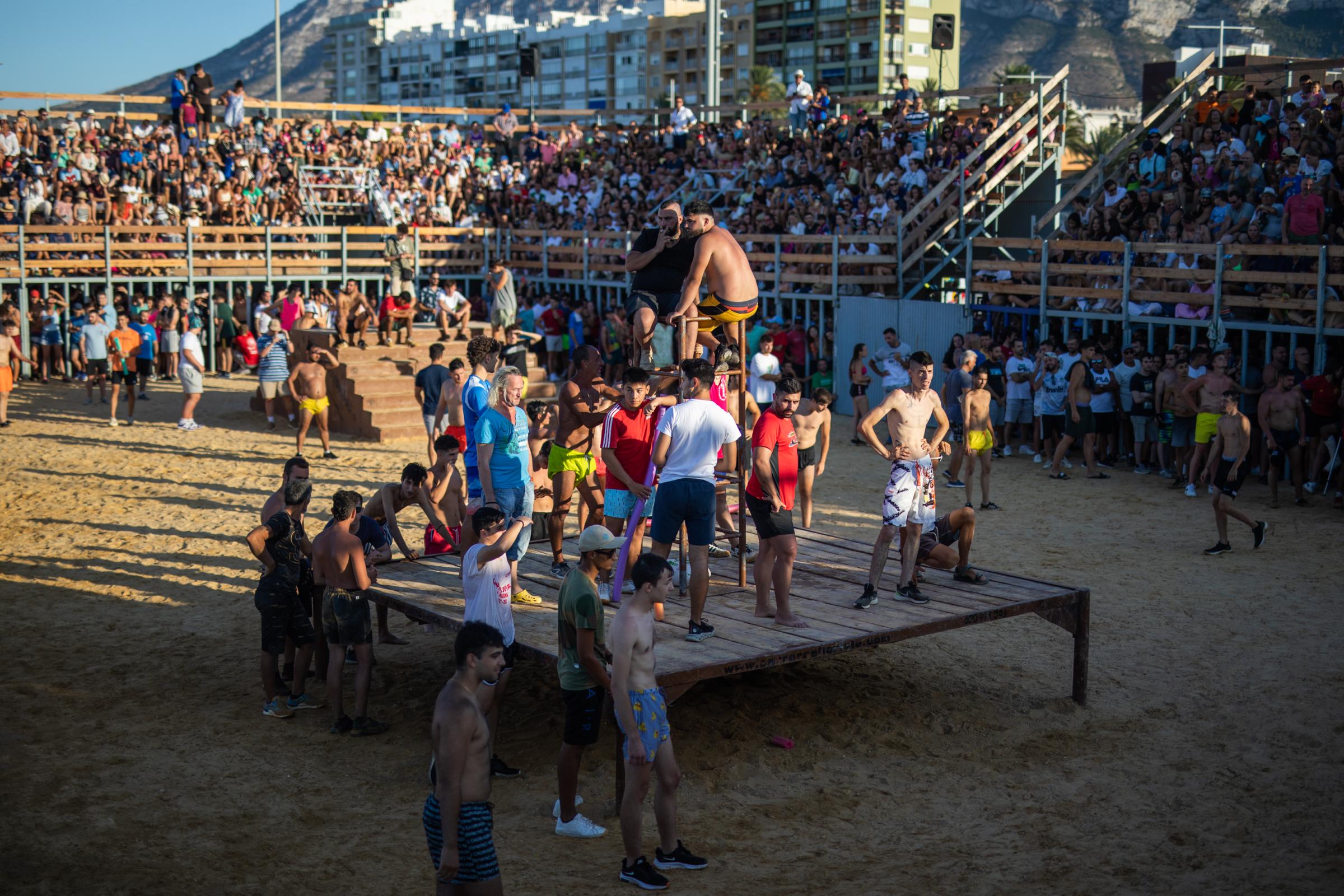 At 'Bous A La Mar', Revelers Take Plunge To Dodge Bulls And Beat The Heat - DENIA, SPAIN - JULY 17: Participants waiting for a bull...