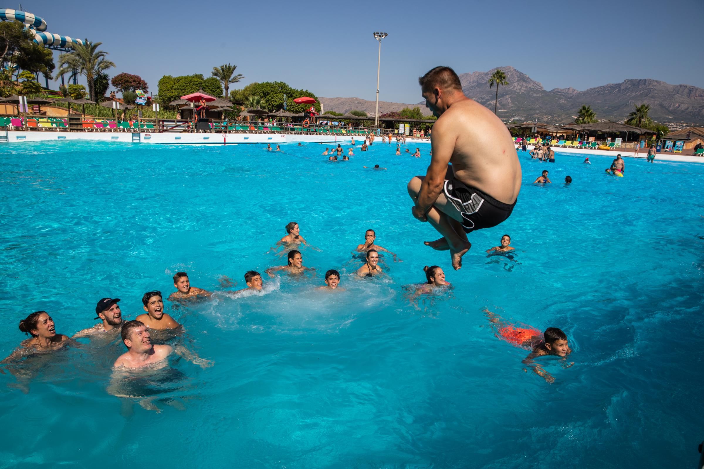 Heatwave Sweeps Across Spain - BENIDORM, SPAIN - JULY 16: Tourist jumps into the giant...