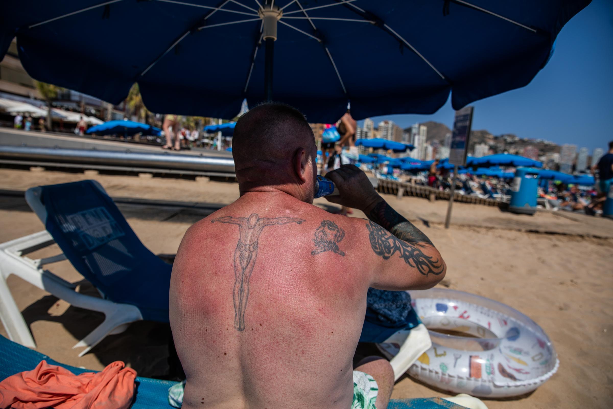 Heatwave Sweeps Across Spain - BENIDORM, SPAIN - JULY 16: An English tourist sunbathes...