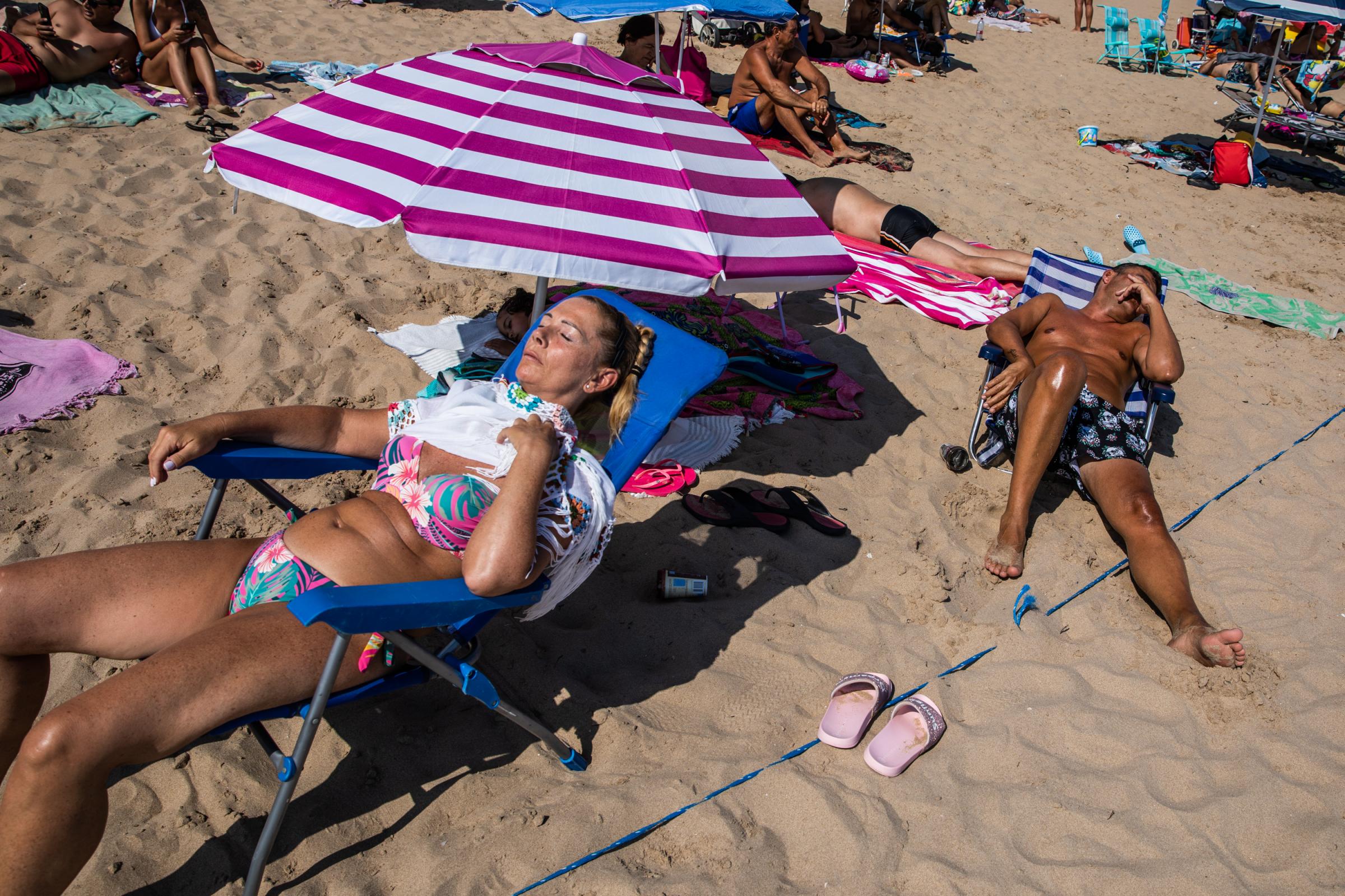 Heatwave Sweeps Across Spain - BENIDORM, SPAIN - JULY 16: Tourists sleep and sunbathe on...