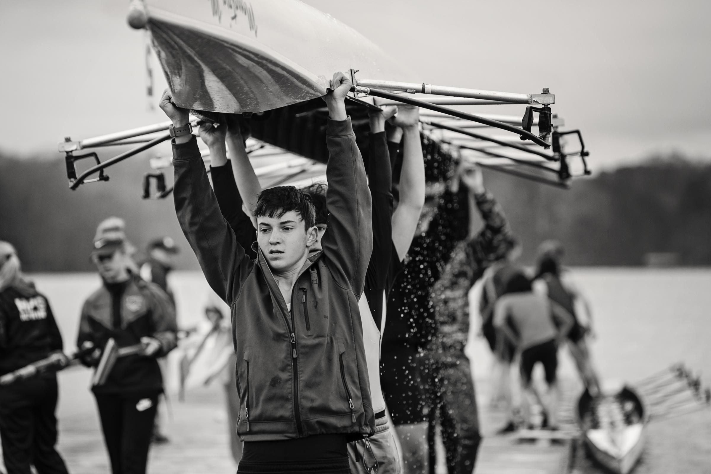 Growing Up - Asheville Youth Rowing crew members lift their boat after...