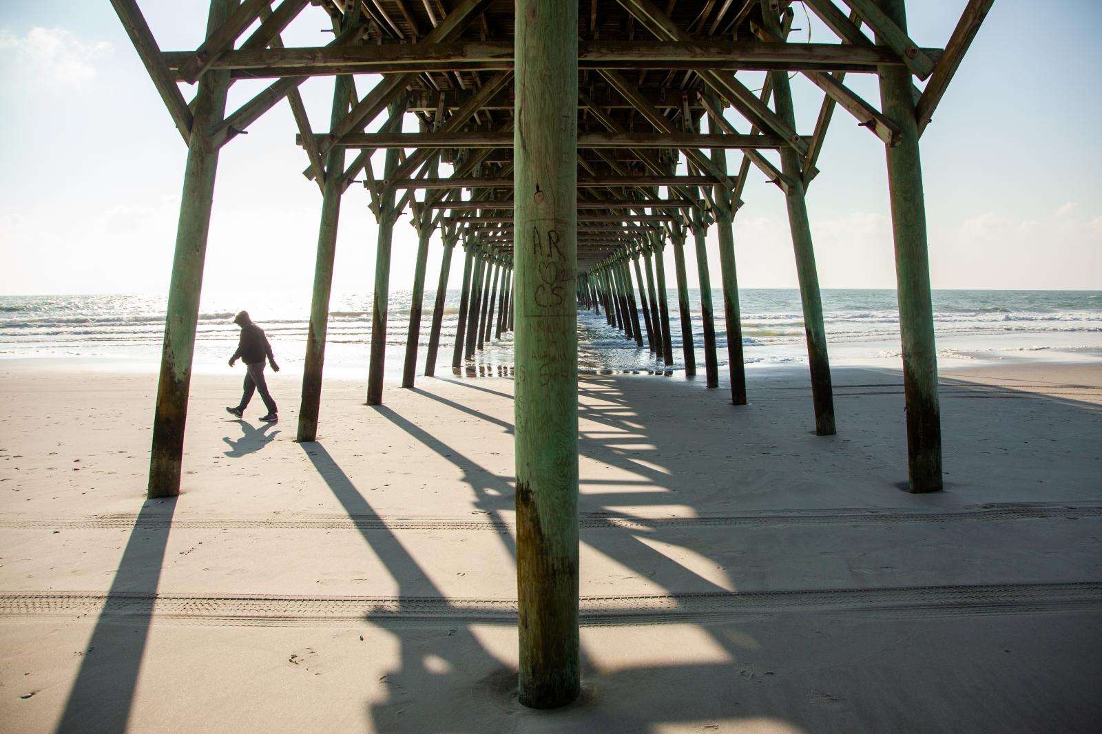 Walking Under the Pier on the South Carolina Coast