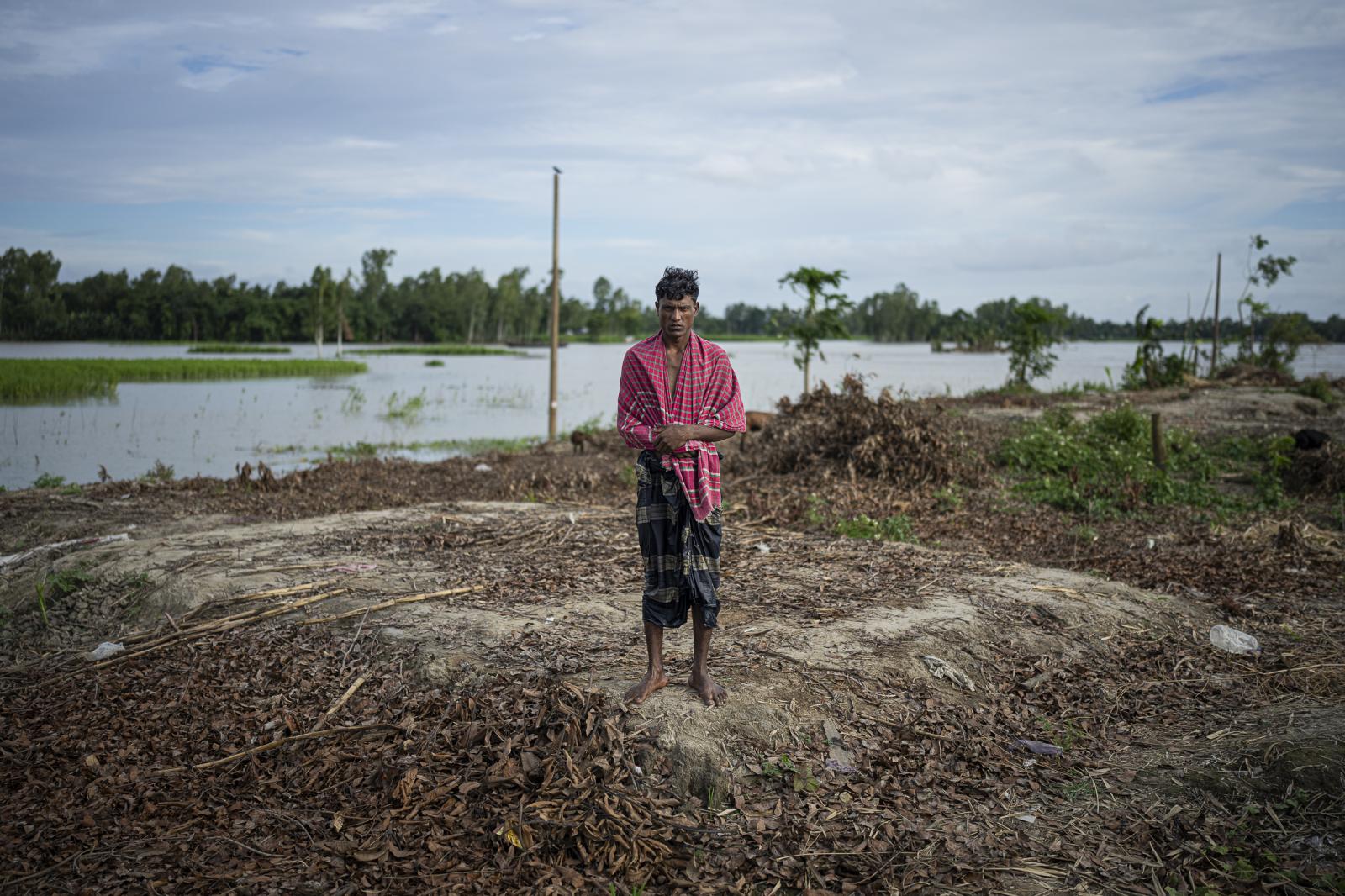 Beyond the storm -  Bokul Miah, 27, pictured where his house used to be. The...