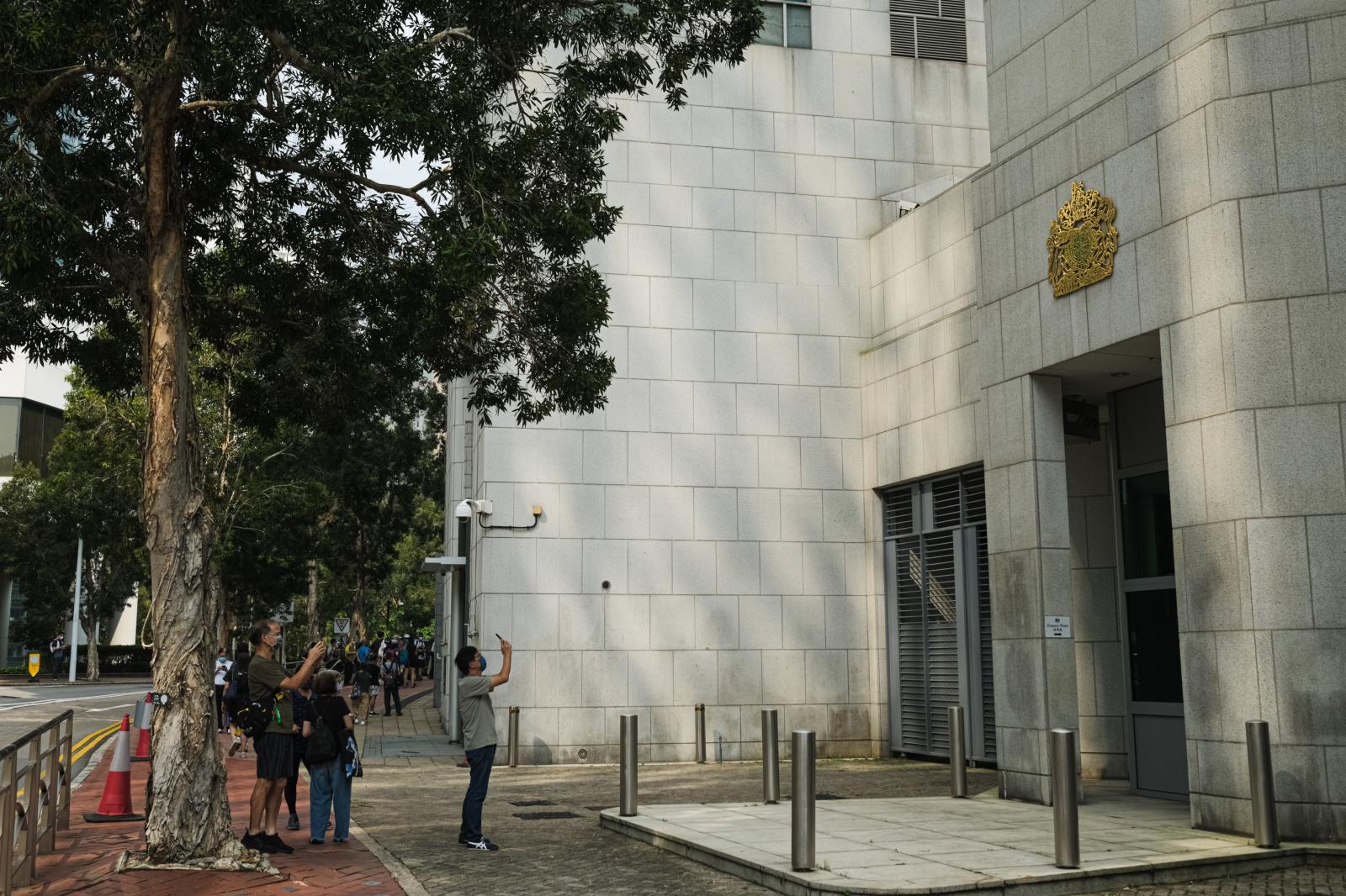 People take photos outside British embassy
