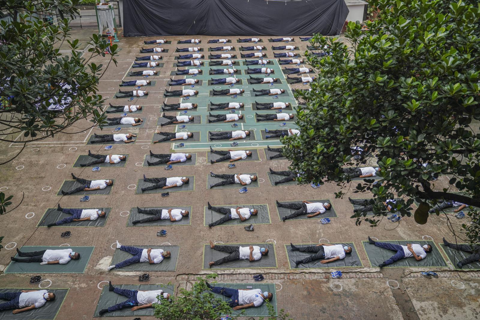 Bangladesh police attend a yoga session during COVID-19. | Buy this image