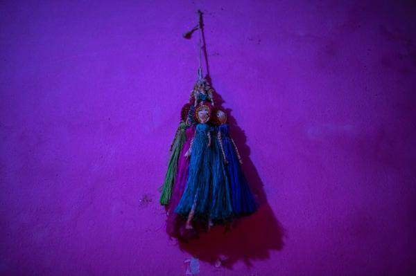Image from Woman in a Male Body -  A transgender woman hangs dolls in her bedroom in Dhaka,...