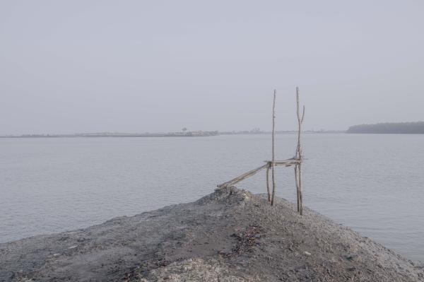 Image from Salt Water's Roar -   Two poles of a house remain after the river erosion of...