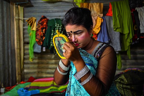 Image from Traditional Circus of Bangladesh -  A circus acrobat applying make-up in preparation for the...