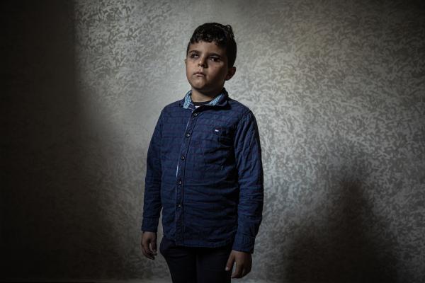 Gaza's Injured Struggle To Recover Six Months After Ceasefire - GAZA CITY, GAZA - NOVEMBER 25: Mohammed Shaban, 8, poses for a photo in his house in the town of...