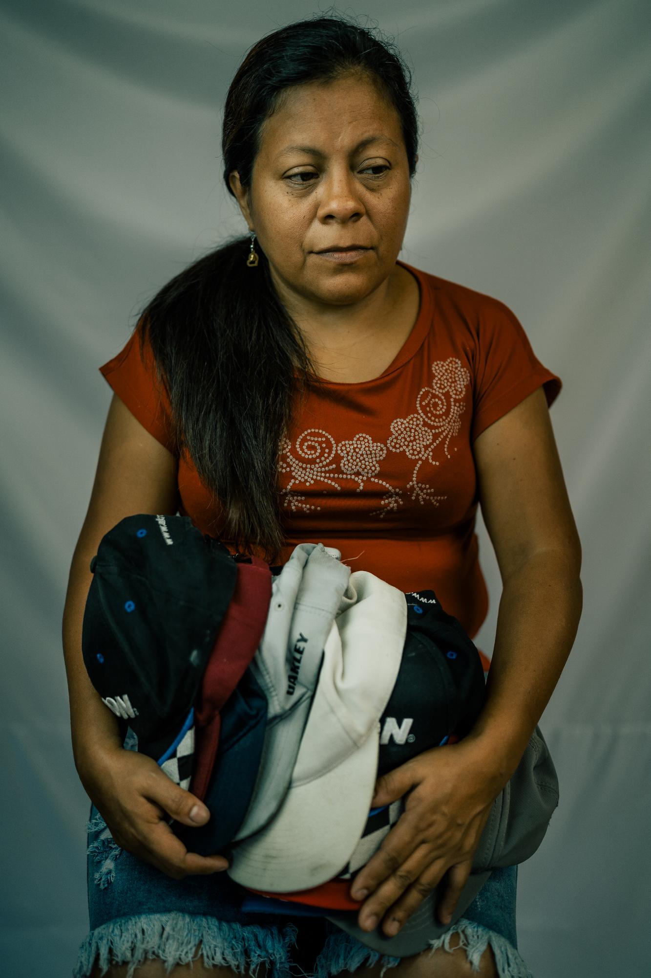 The Washington Post: Resistencia  - Maria poses with a collection of hats from her son, Michael, who was shot and killed by police...