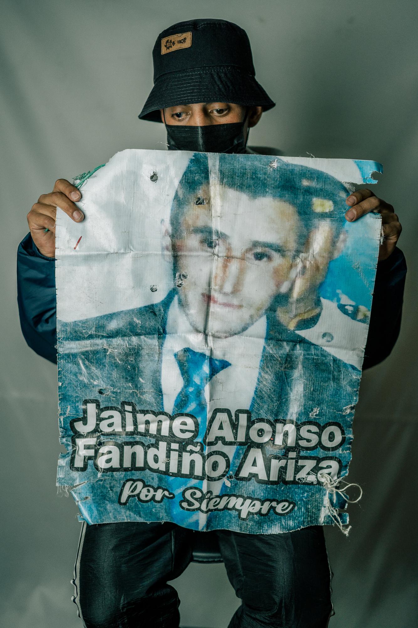The Washington Post: Resistencia  - Topo poses with a poster of a Jamie, who was killed during the protests by police in Bogotá,...