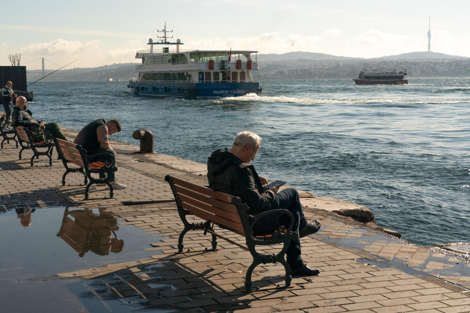 Residents sit on benches overlo...l, Turkey in the early morning.