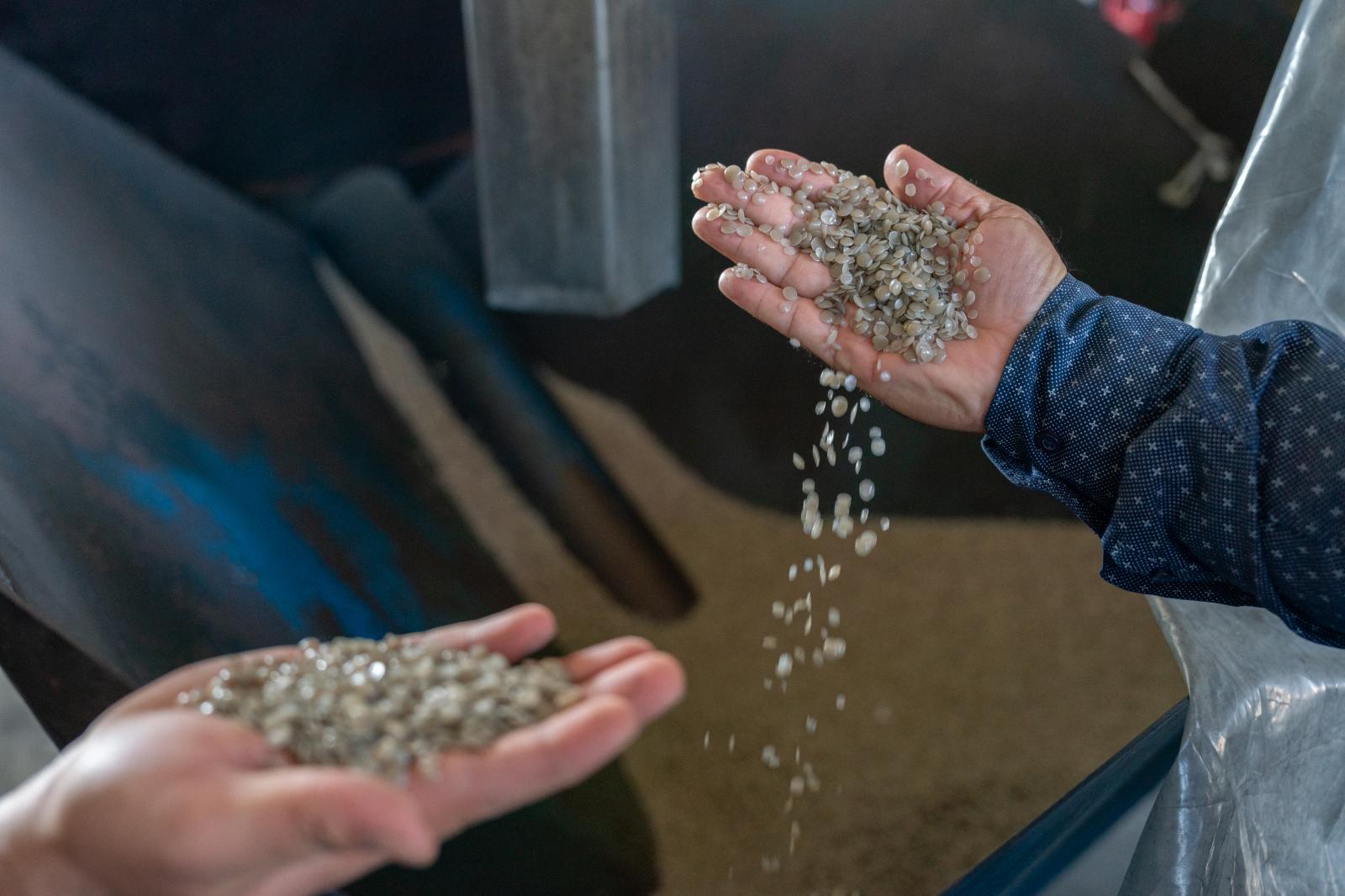 A worker demonstrates the final...tic materials to be used again.