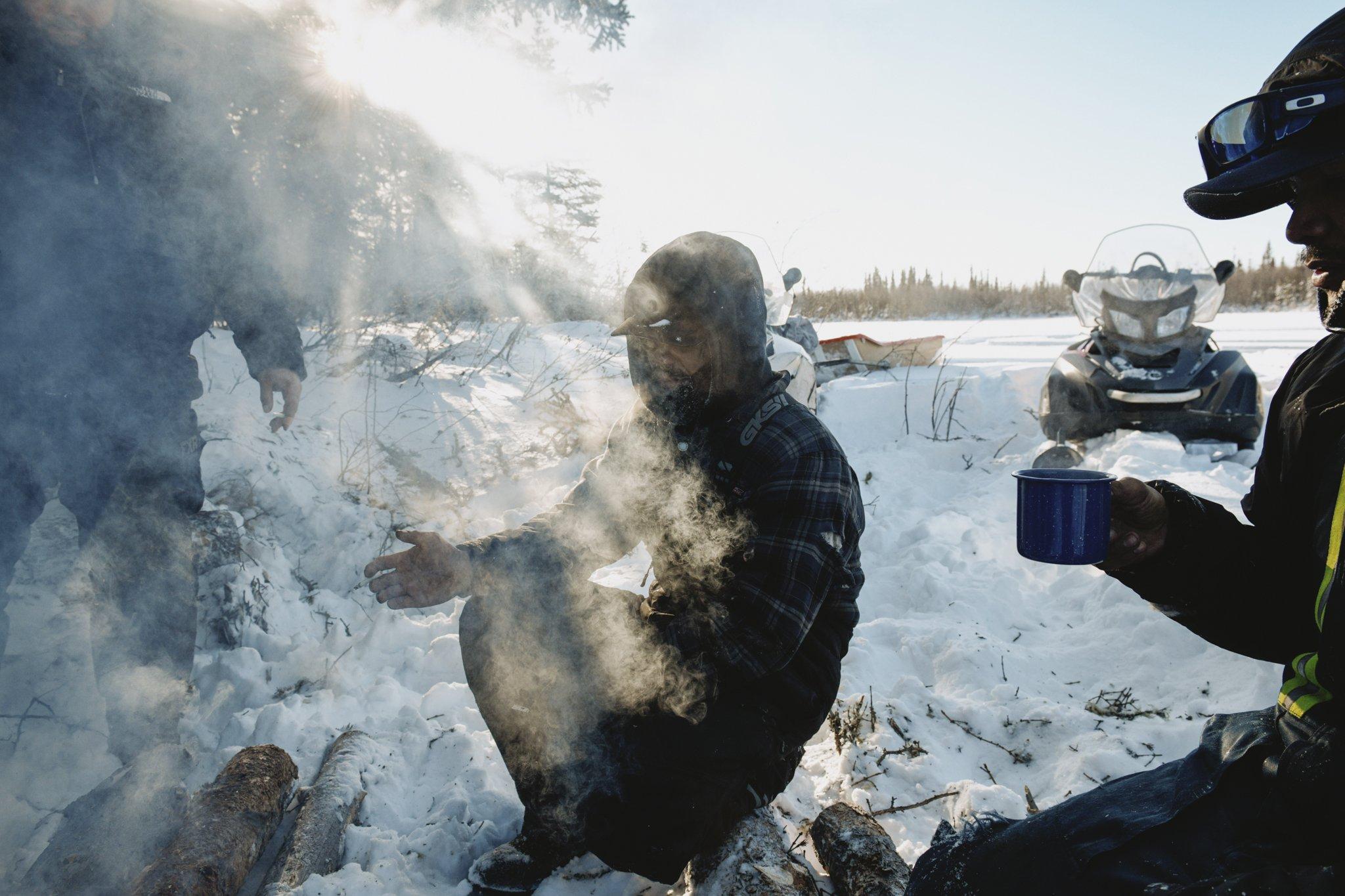 The Last Trappers - National Geographic - Francis Lafferty, Shaun Tobac and Joseph Tobac warm up by...