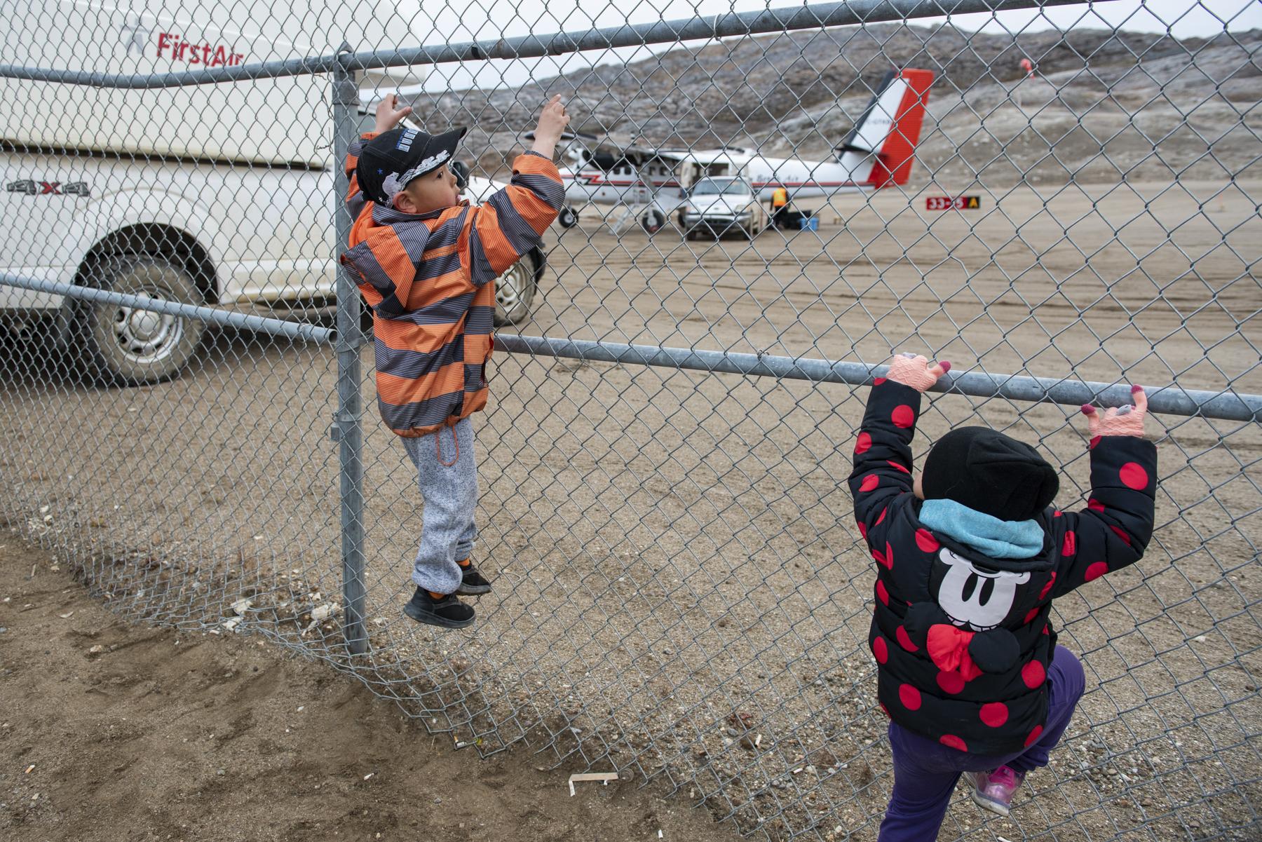No Place to Grow Old - The Globe and Mail - Children play on a fence at the Kimmirut airport on...
