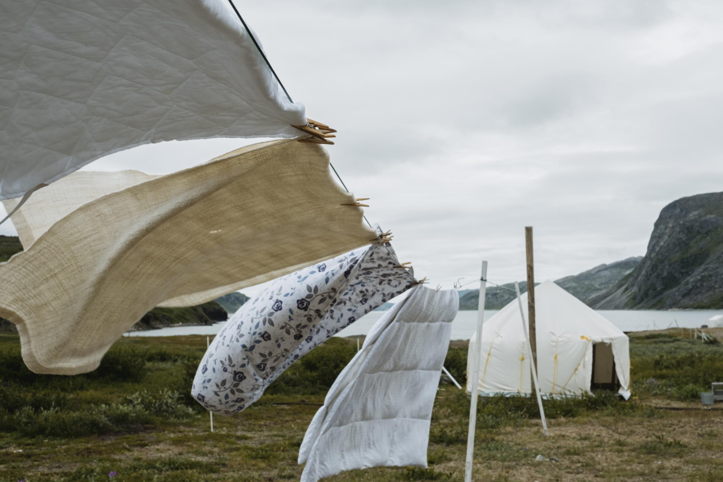 Place of Spirits - The Narwhal - Linen and bedsheets hang to dry at Torngat Mountains...