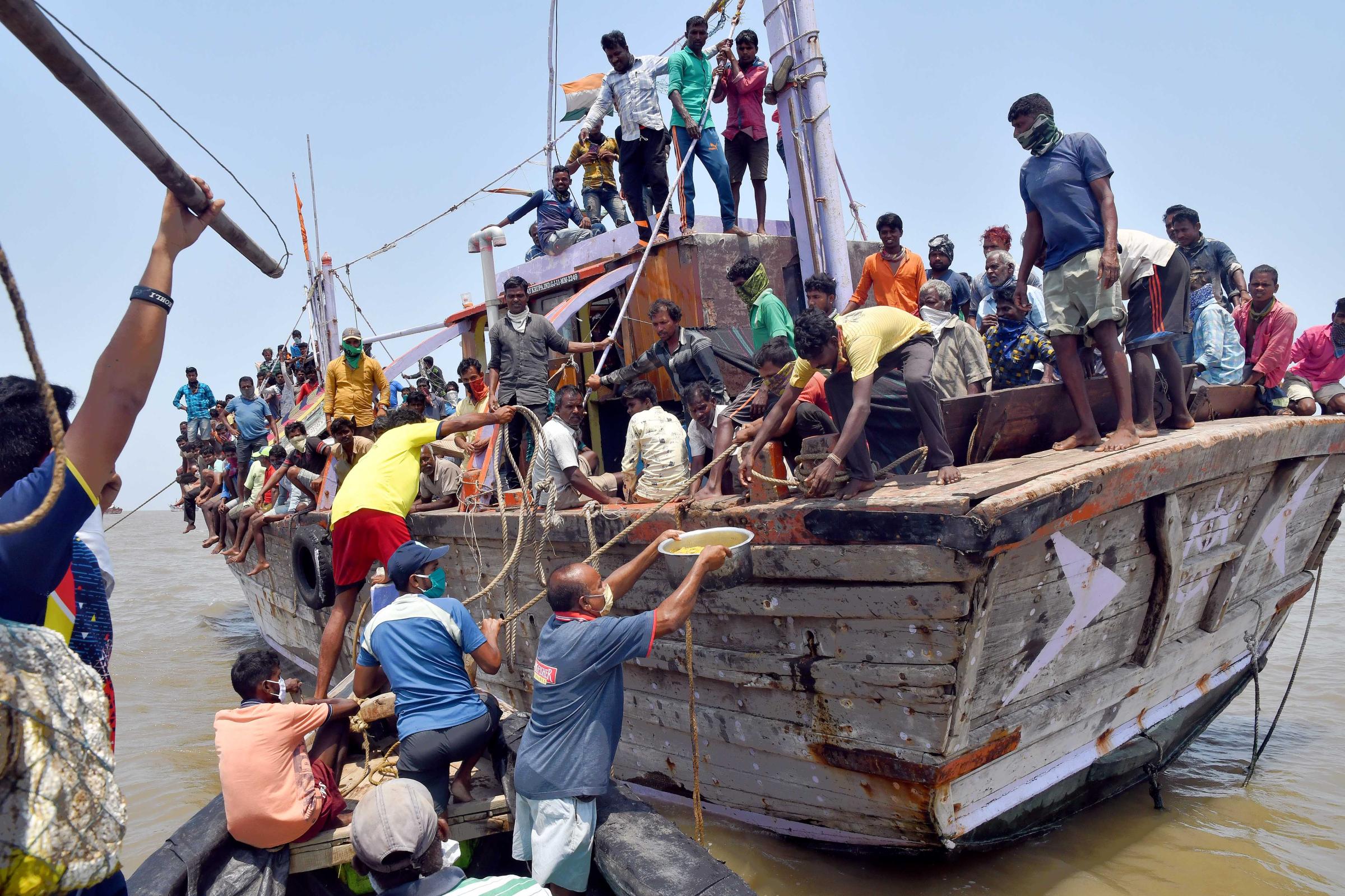 COVID-19: A Long Ordeal at Sea  -   Local fishermen and members of the Dahanu Machhimar Society served the stranded fishermen poha...