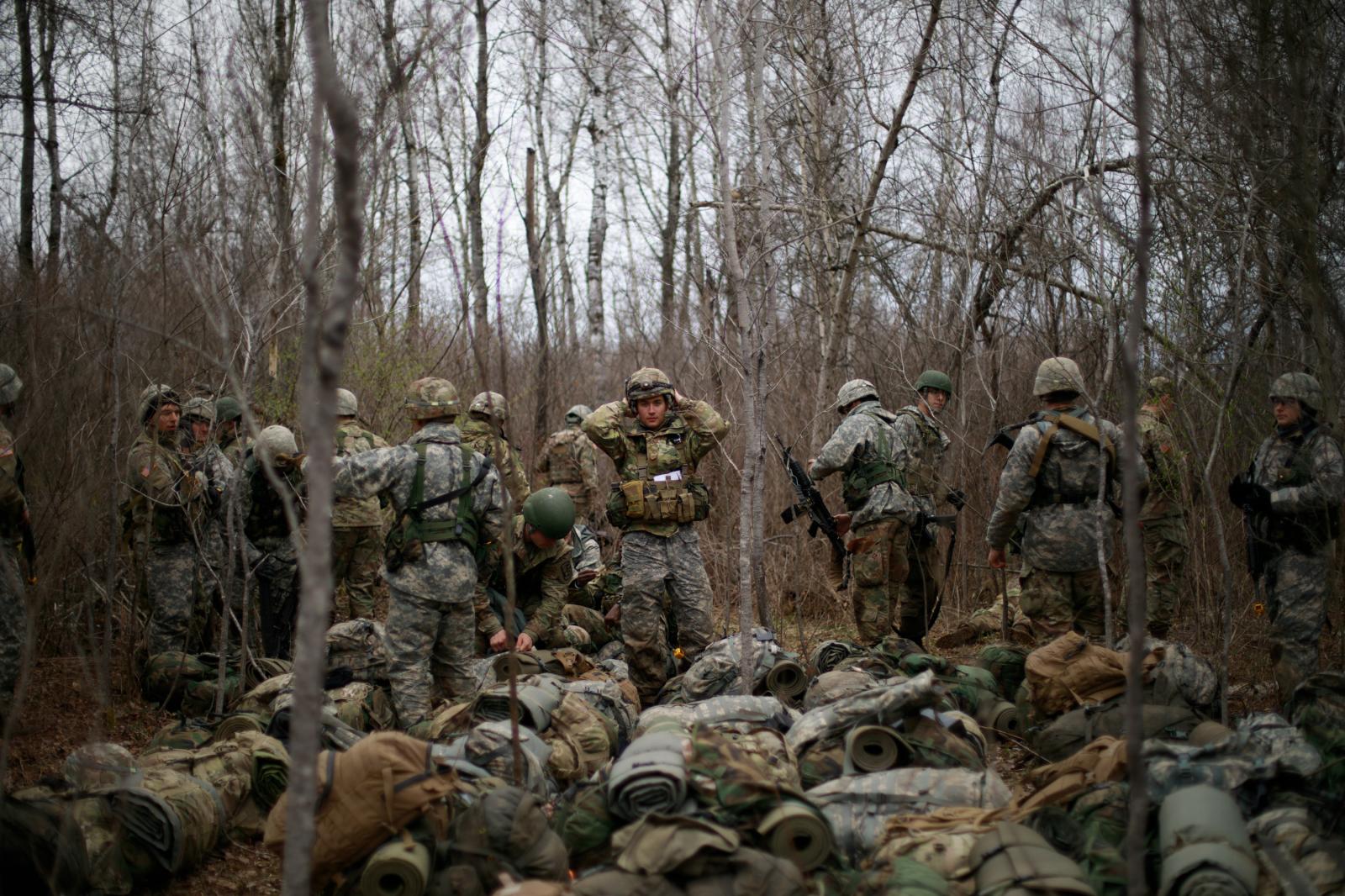 Army ROTC - CDT Dargis fixes his helmet after a momentary pause in...