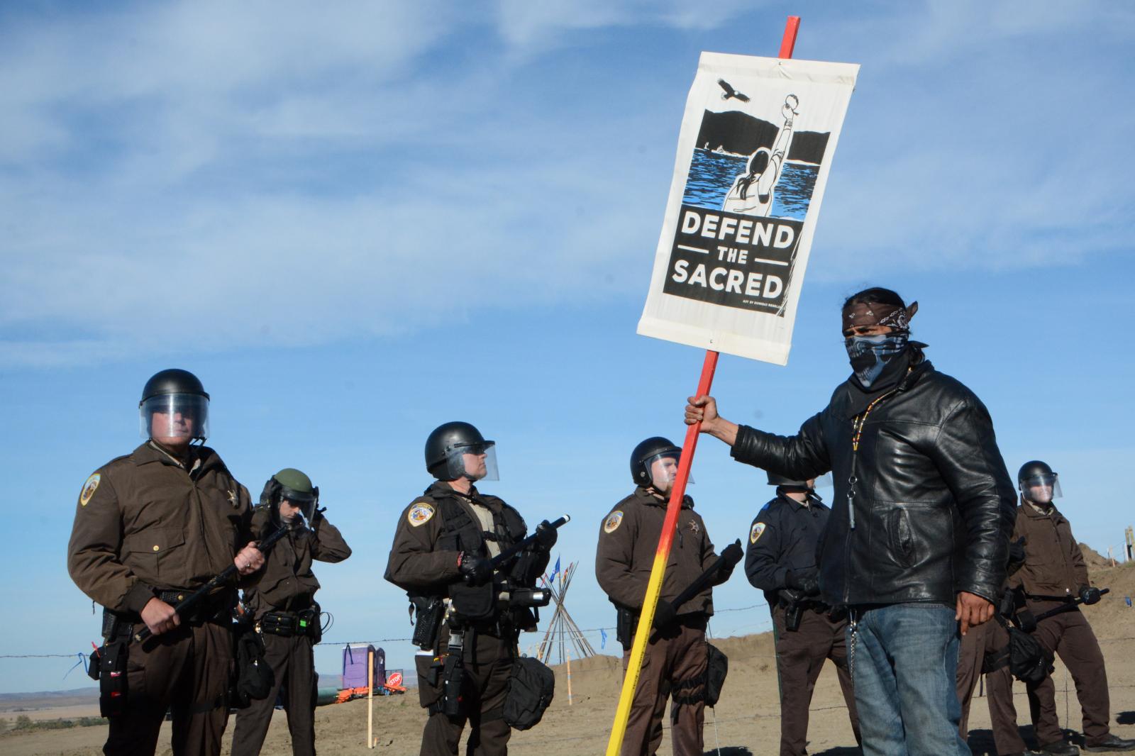 Water Protector and Police at Pipeline Site, Standing Rock