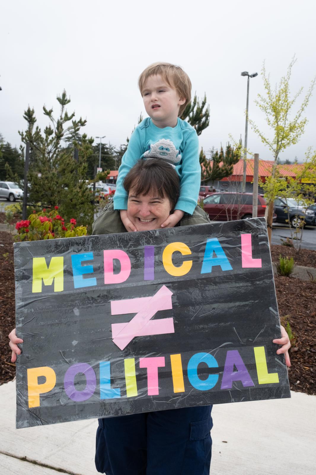 Bans Off Our Bodies Rally Florence Oregon - Mother and child with Medical Does Not Equal Political sign, Bans Off Our Bodies protest,...