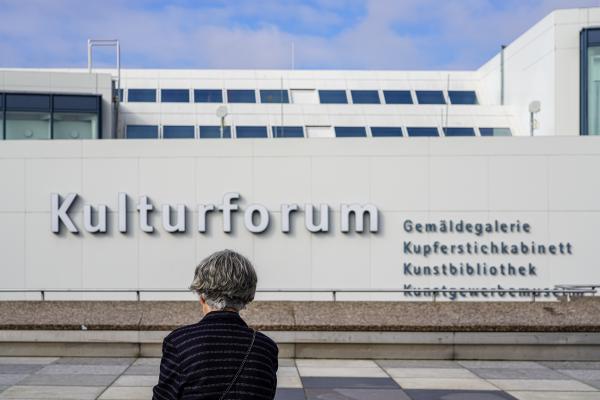 A Lady sits In Front of the Main Entrance of the Kulturforum Berlin | Buy this image