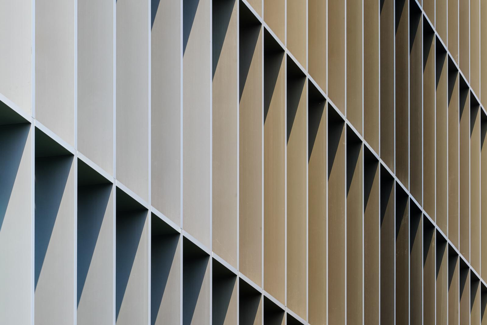 Facade of a building in Milan in beige and brown tones