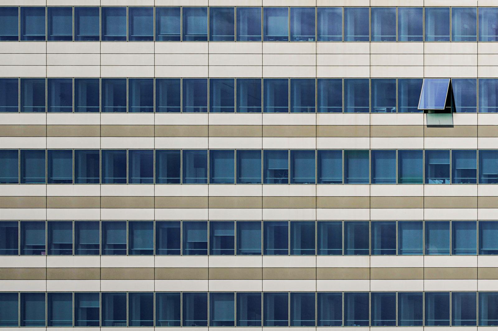 An open window in the facade of the Office building of the Insurance Company Vittoria Assicurazioni. | Buy this image