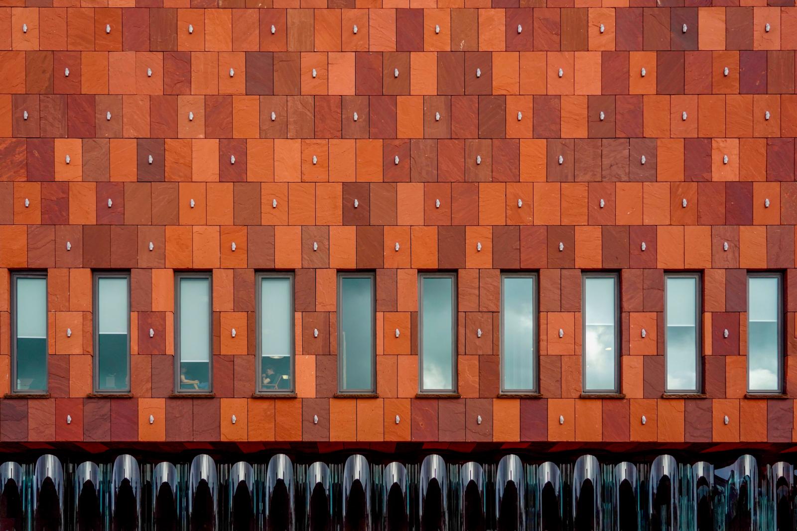 A facade with an undulating glass curtain | Buy this image