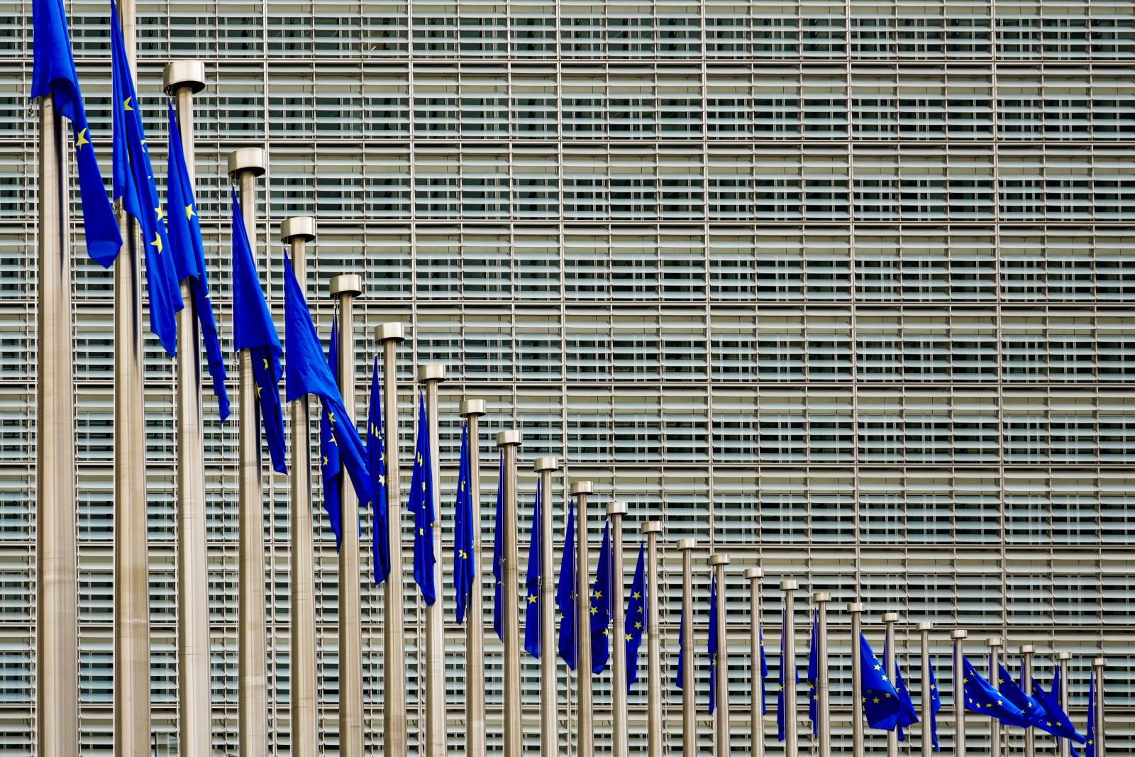 A Row of European Union Flags: The Berlaymont Building, Headquarters of the European Commission in Brussels, Belgium