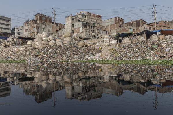 Dangerous job of recycling - View to the Islamabag slum from the Buriganga river, one of the most important in the country due...
