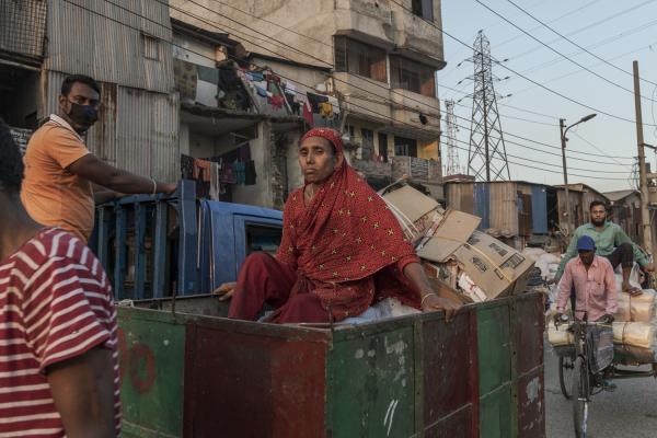 Dangerous job of recycling - A woman travels in a small vehicle used to transport the materials collected for the day. On Alam...