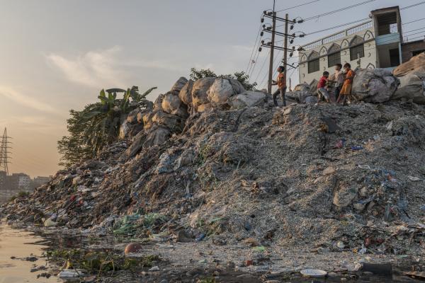 Dangerous job of recycling - Some children from the Old Dhaka neighborhood play on a mountain of garbage and plastic waste...