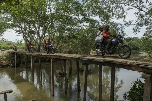 The journey trough Darien Gap - The migrants are transported on motorcycles to the jungle camps. The motorcyclists are local...
