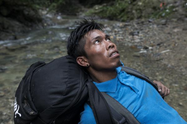 The journey trough Darien Gap - Fernando, a Venezuelan migrant, leans on a rock as he takes a breath and asks God to give him...