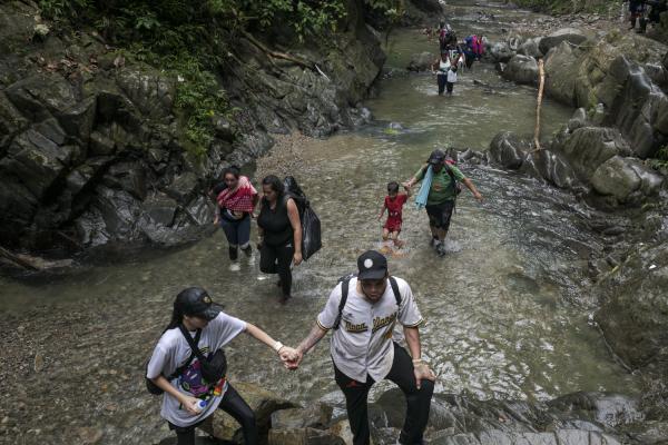 The journey trough Darien Gap - Different families traveling on the bed of one of the rivers of the Tapon del Darien. In the...